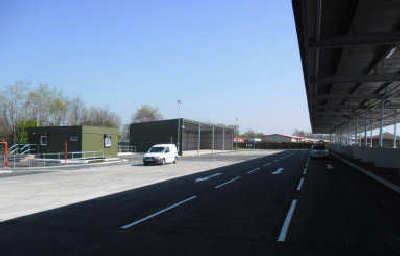 view of recycling centre with van and canopy